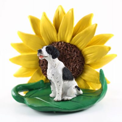 Pointer Black Figurine Sitting on a Green Leaf in Front of a Yellow Sunflower