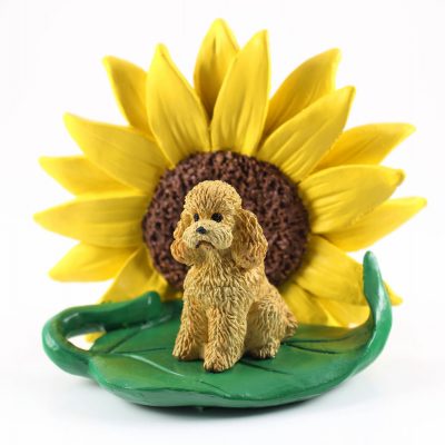 Poodle Apricot Sport Cut Figurine Sitting on a Green Leaf in Front of a Yellow Sunflower