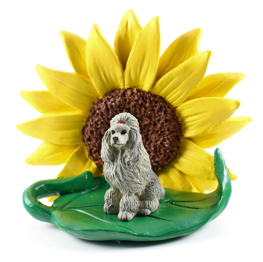 Poodle Gray Figurine Sitting on a Green Leaf in Front of a Yellow Sunflower