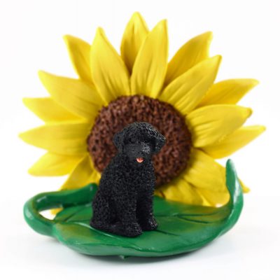 Portuguese Water Dog Figurine Sitting on a Green Leaf in Front of a Yellow Sunflower