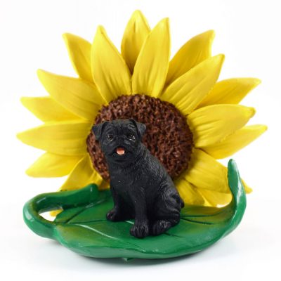 Pug Black Figurine Sitting on a Green Leaf in Front of a Yellow Sunflower