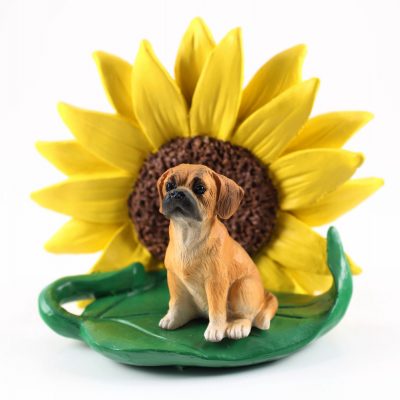 Puggle Figurine Sitting on a Green Leaf in Front of a Yellow Sunflower