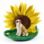 Saint Bernard Rough Coat Figurine Sitting on a Green Leaf in Front of a Yellow Sunflower