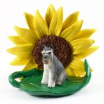 Schnauzer Gray Figurine Sitting on a Green Leaf in Front of a Yellow Sunflower