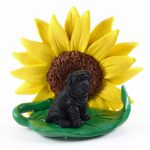 Shar Pei Black Figurine Sitting on a Green Leaf in Front of a Yellow Sunflower