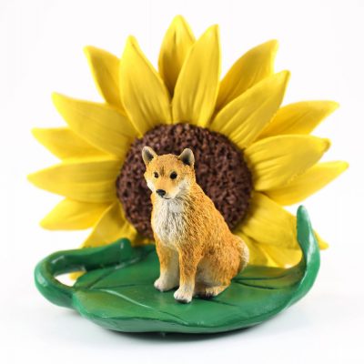 Shiba Inu Figurine Sitting on a Green Leaf in Front of a Yellow Sunflower