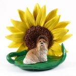 Shih Tzu Brown Figurine Sitting on a Green Leaf in Front of a Yellow Sunflower
