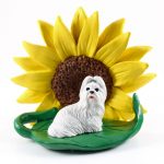 Shih Tzu White Figurine Sitting on a Green Leaf in Front of a Yellow Sunflower
