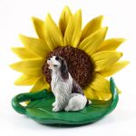 Springer Spaniel Brown Figurine Sitting on a Green Leaf in Front of a Yellow Sunflower