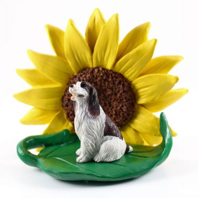 Springer Spaniel Brown Figurine Sitting on a Green Leaf in Front of a Yellow Sunflower