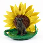 Staffordshire Bull Terrier Figurine Sitting on a Green Leaf in Front of a Yellow Sunflower