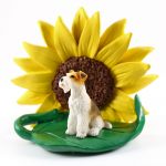 Wire Fox Terrier Figurine Sitting on a Green Leaf in front of a Yellow Sunflower